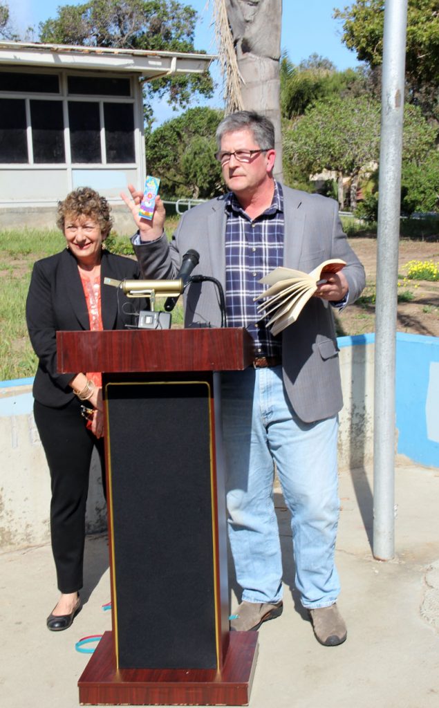 At the March 27, 2014 joint press conference to announce the Pacific View purchase price, Councilmember Tony Kranz prepares to read "The Road Not Taken" by Robert Frost as School Board President Marla Strich looks on.