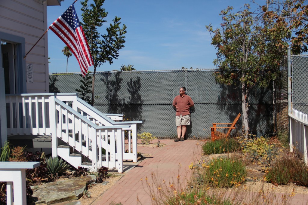 Kranz leans against the chain-link fence outside the old schoolhouse, a fence he hopes will yield to open space, sculptures and flowers.